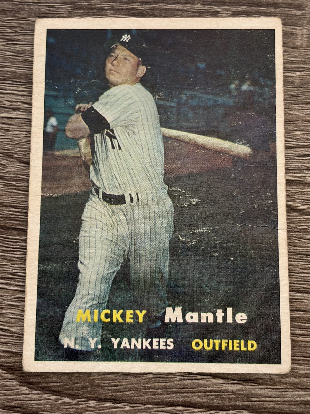 Straight-down front view of the 1957 Topps Mickey Mantle #95 showing all four white borders, the left border noticeably wider than the right