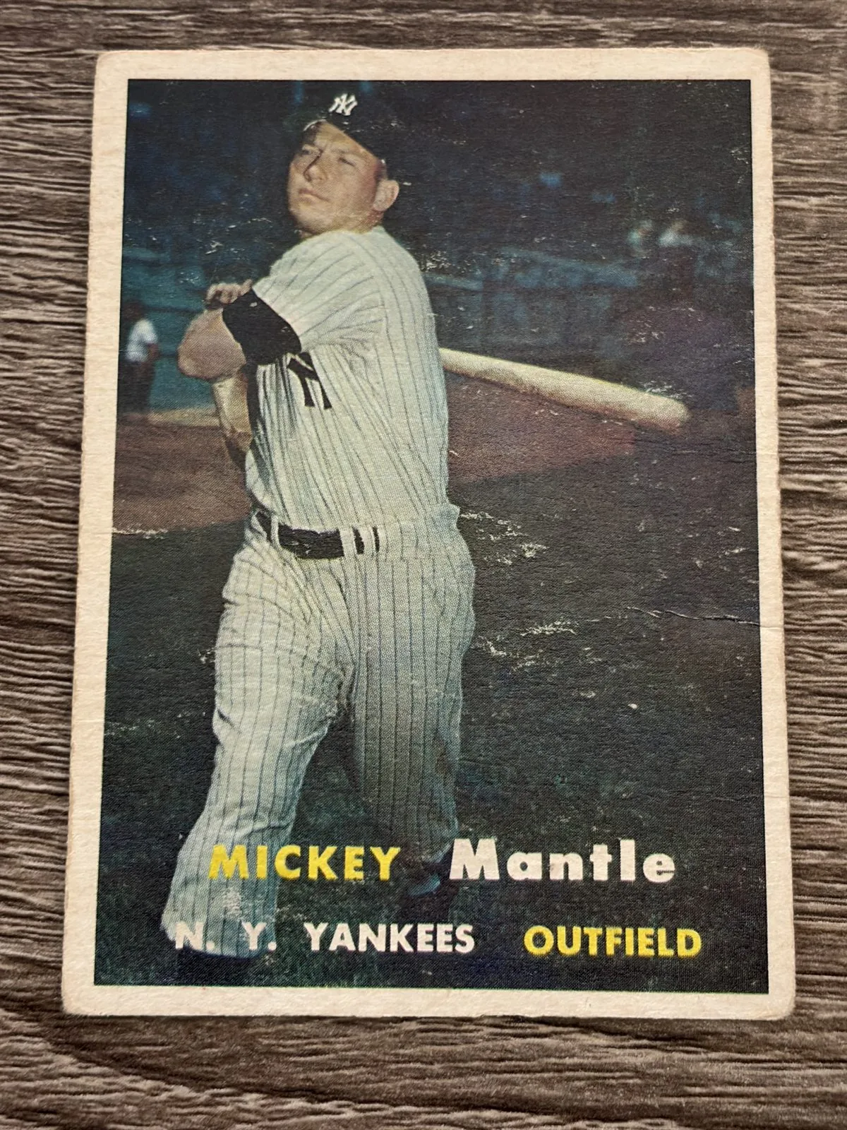 Straight-down front view of the 1957 Topps Mickey Mantle #95 showing all four white borders, the left border noticeably wider than the right